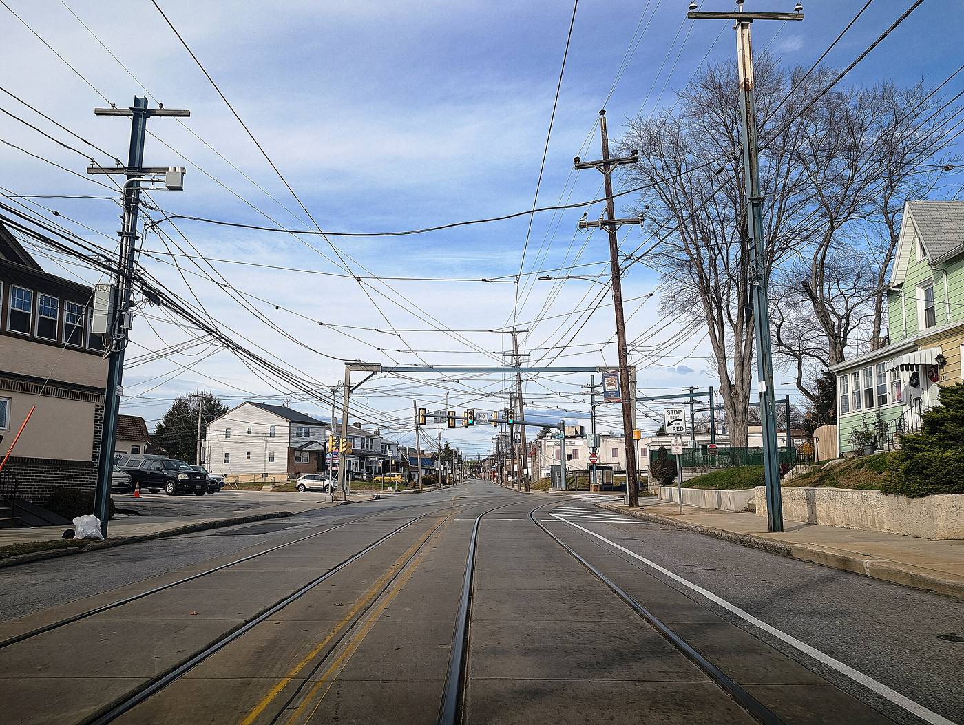 South Springfield Road in Clifton Heights, where the Sharon Hill line splits off. Trolley tracks in the street and houses on both sides of them.