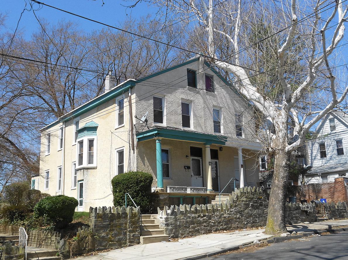 A twin in Darby under a sycamore. One shared wall, one porch roof over both front doors, and two separate tax bills.